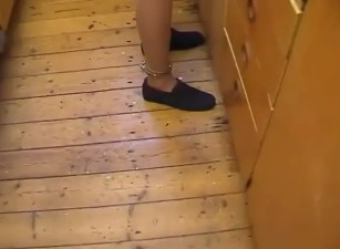 A naked slave in stockings and shackles