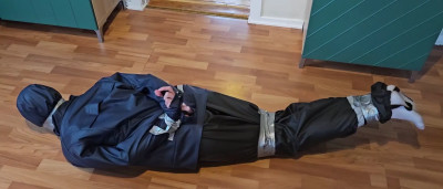 Tape gagged and bound in raincoat and rainpants