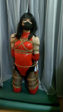 CD half-suspended, kneeling and bound