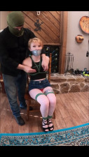 Izzie chairtied stripped tape gagged and struggling