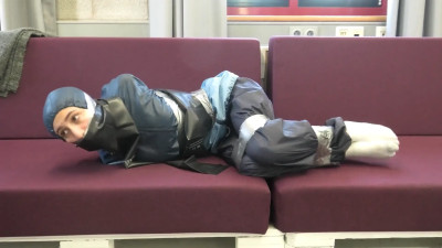 Rey Sanson bound and gagged in a shiny nylon Rainwear