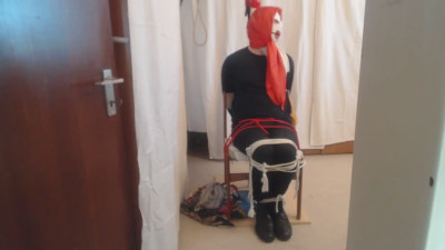Tied and gagged with silkscarves on a chair to a pole