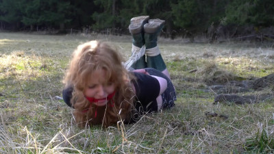 Ginger Goddess hogtied in the meadow