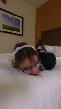 Maid frogtied and ballgagged struggling on the bed
